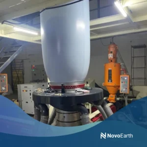 An industrial polymer processing machine producing compostable polymer materials in a manufacturing facility for sustainable and biodegradable plastic alternatives.