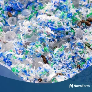 Close-up of fragmented plastic particles and microplastics mixed with organic debris, illustrating environmental pollution and material breakdown.
